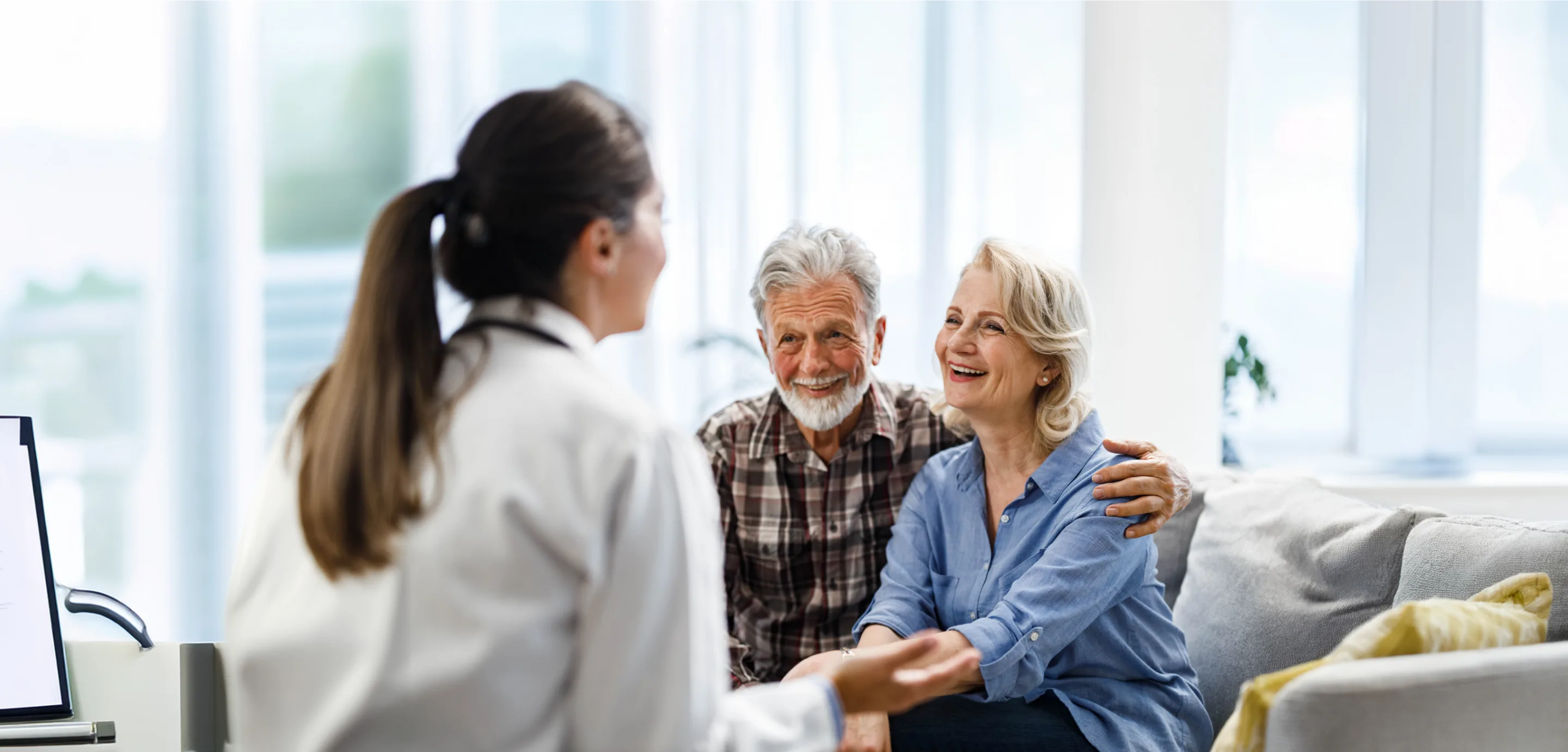 old couple reviewing  speaking with medical professional