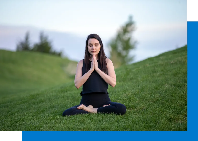 Woman doing Meditation in grass land